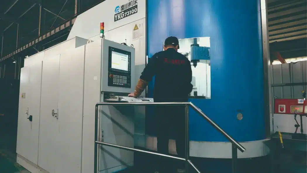 TANHON official facility photograph labelled gear-grinding equipment with an operator at the machine control